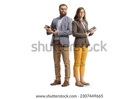 Full length shot of a man and woman posing and holding books isolated on white background