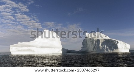 Iceberg floating in the Gabriel Strait near Lower Savage Islands, Nunavut, Canada Royalty-Free Stock Photo #2307465297