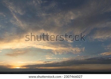 Landscape at sunset. Cirrus clouds. Tragic gloomy sky. Panorama. Crimson twilight. Royalty-Free Stock Photo #2307466027