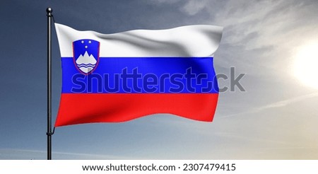 Slovenia national flag cloth fabric waving on beautiful grey sky Background.