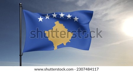Kosovo national flag cloth fabric waving on beautiful grey sky Background.
