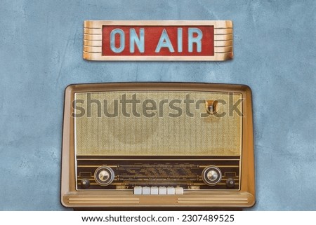 Vintage illuminated studio On Air sign with old radio