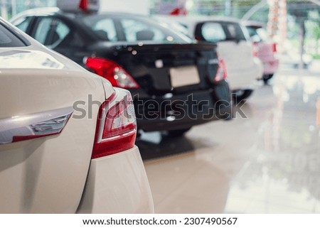 Parking for new cars on a white floor, displaying photographs of new cars in a showroom, and waiting for sales from branch dealers and new car service facilities.