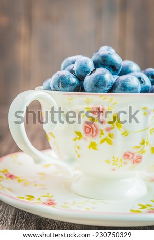 Blueberry cup on wooden background - vintage effect style pictures