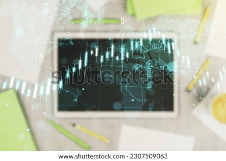 Double exposure of abstract creative financial diagram with world map and modern digital tablet on background, banking and accounting concept