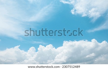 Beautiful blue sky with white fluffy clouds in spring season. Nature background.