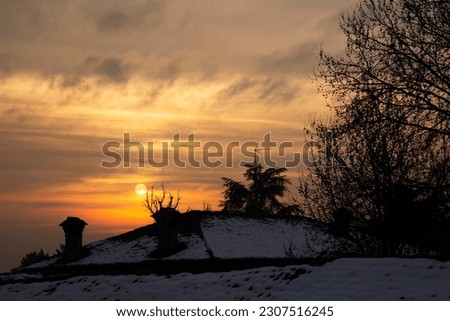Romantic sunset with warm light and skyline of the city and the roofs of houses