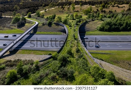 Forest aerial wildlife crossing forming a safe natural corridor bridge for animals to migrate between conservancy areas. Environment nature reserve infrastructure engineering eco passage from above Royalty-Free Stock Photo #2307531127
