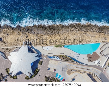 Aero Photography. View from flying drone. Panoramic cityscape of old town and an incredibly beautiful beach. San Paul il Bahar (San Pawl il-Baħar) Malta. Top view