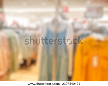 Defocused Abstract Background close up of female Apparel store hanging on rack in departement store inside modern Shopping Mall or Shopping Center. with vintage tone effect