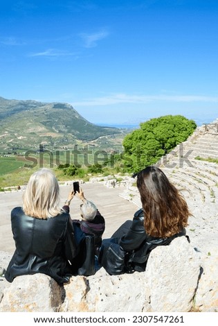 People taking selfie photo at Ancient Greek theater at Segesta.