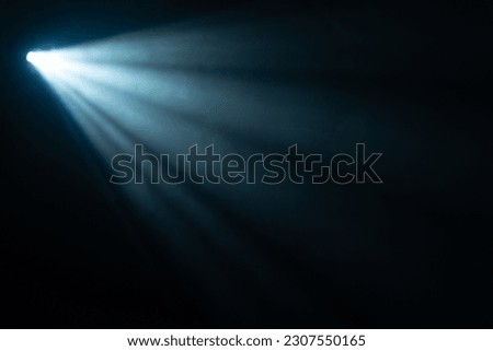 blue spotlight light beam on black background Royalty-Free Stock Photo #2307550165