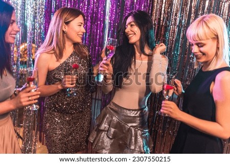 Group of female friends dancing in the club 