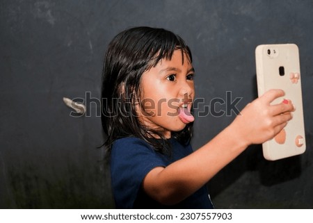 Asian girl expression in front of mobile phone
