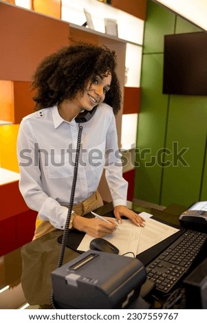 Receptionist having a call and looking busy Royalty-Free Stock Photo #2307559767