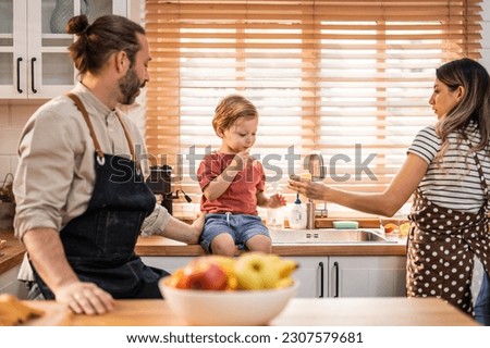 Caucasian family spending leisure free time together indoors in house. Happy family activity, Little baby boy children playing with parents, enjoy holiday weekend with mother and father in living room