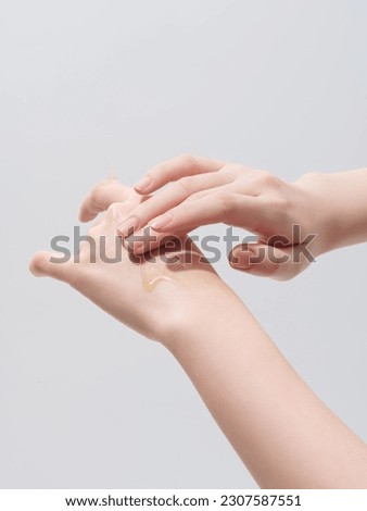 Skin care Essence on the back of the hand and fingers Royalty-Free Stock Photo #2307587551