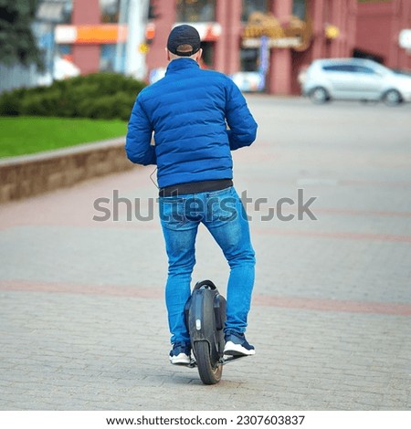 Man ride on monowheel. Man commuting to work, riding electric unicycle (EUC). Man driving electric mono wheel, ecological transportation in city.
 Royalty-Free Stock Photo #2307603837