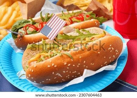 Plate with tasty hot dogs on table, closeup. Memorial Day celebration
