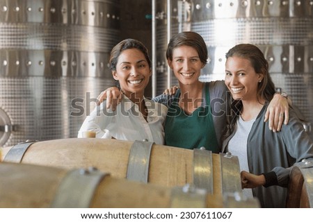 Portrait smiling women in winery cellar Royalty-Free Stock Photo #2307611067