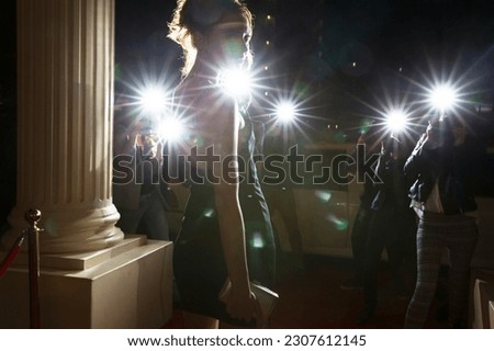 Silhouette of celebrity being photographed by paparazzi photographers at event Royalty-Free Stock Photo #2307612145