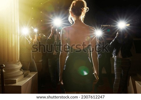 Silhouette of celebrity in black dress being photographed by paparazzi Royalty-Free Stock Photo #2307612247