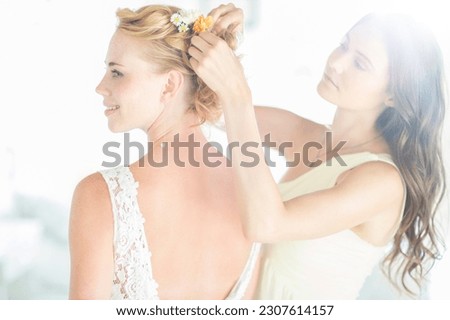Bridesmaid helping bride with hairstyle in garden Royalty-Free Stock Photo #2307614157