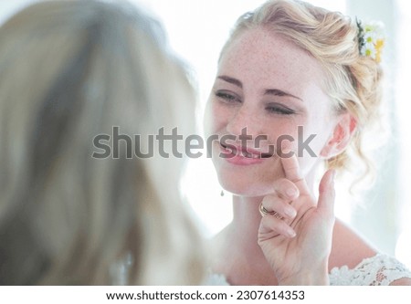 Matron of honor and bride facing each other and smiling Royalty-Free Stock Photo #2307614353