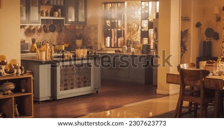 Wide Shot of an Empty Cosy Kitchen Decorated with Indian Style. Stylish Traditional South Asian Home with Utensils and Wide Window Letting the Spring Warmth and Light in. Vintage Warm Aesthetic Royalty-Free Stock Photo #2307623773