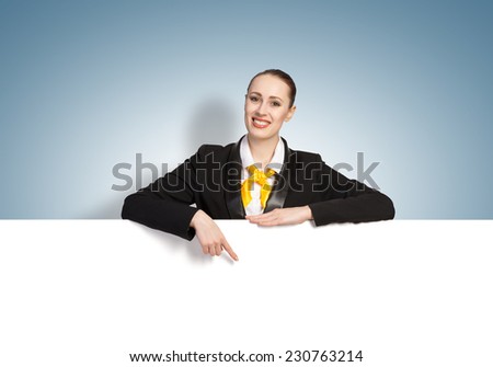 Young pretty woman with white blank banner on color background