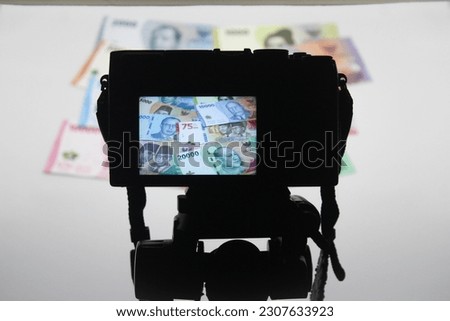 Shoot picture of banknote money paper indonesia rupiah. display on the camera screen.