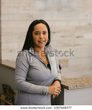 Latina office employee in place of work by counter