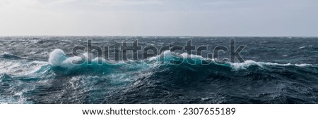 Beautiful seascape - waves and sky with clouds with beautiful lighting. Stormy sea, Bad weather. Gale. Rough sea.