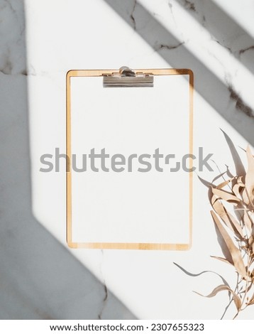 Clipboard with blank paper with copy space on white background with shadows. Minimal concept. Menu board, business template. Top view