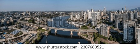 Vancouver, BC, Canada - panoramic aerial city view of the areas left and right the famous False Creek in Vancouver downtown with Cambie Bridge and parts of Vancouver Skyline 