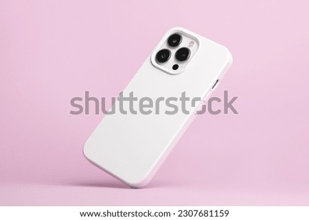 iPhone 14 Pro max starlight in white soft silicone case falls down back view, phone cover mockup isolated on pink background
