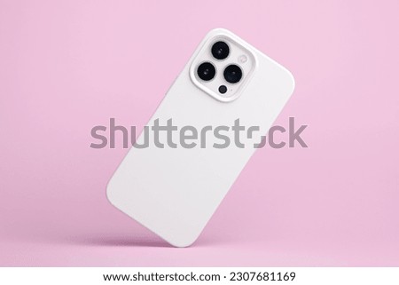 iPhone 14 Pro max starlight in white soft silicone case falls down back view, phone cover mockup isolated on pink background Royalty-Free Stock Photo #2307681169