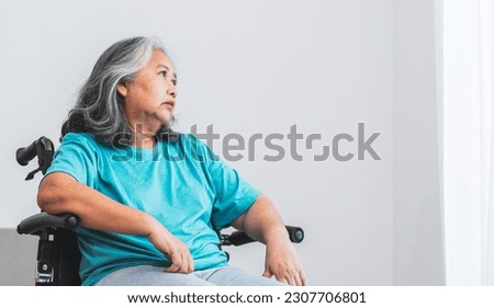 Asian elderly woman patient sat on wheelchair, which she is saddened from depression. to elderly and health care Our Minds Matter concept. Royalty-Free Stock Photo #2307706801