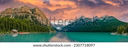 Panorama view of iconic Lake Louise in summer located in Alberta, Canada with pink, ornage colorful sunset sky background overlooking the stunning turquoise lake.  Royalty-Free Stock Photo #2307718097