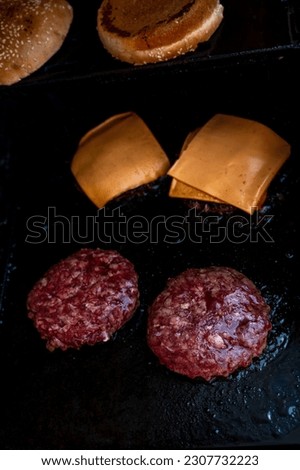 Hamburgers cooking on the grill. Beef or pork barbecue hamburger for hamburger. Hamburgers on bbq .