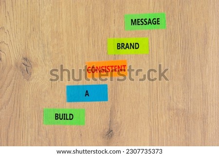 Consistent brand message symbol. Concept words build a consistent brand message on colored paper. Beautiful wooden table wooden background. Business consistent brand message concept. Copy space.