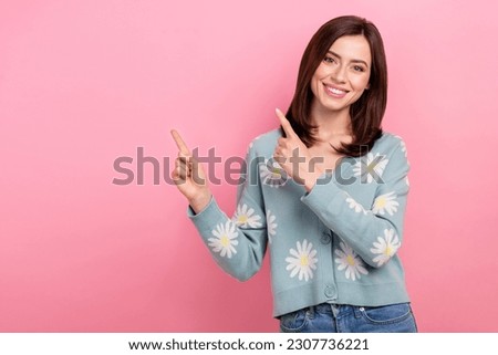 Photo of shiny pretty woman dressed teal outfit pointing two fingers empty space isolated pink color background