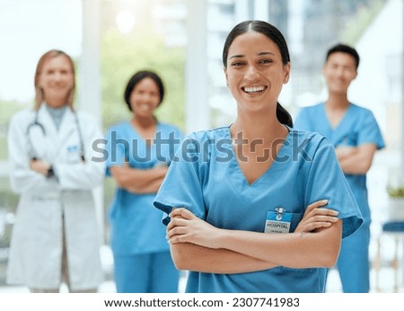 Portrait, medical and a woman nurse arms crossed, standing with her team in the hospital for healthcare. Leadership, medicine and teamwork with a female health professional in a clinic for treatment