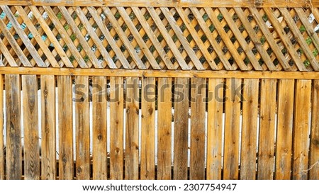 Fence made of wooden slats as Location, Background, texture, copy of space, frame. Abstract natural graphic resource