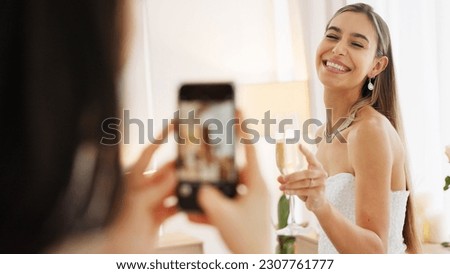 Smartphone photography of bride with champagne glass for wedding celebration to post on social media app. Smile portrait photos or picture taken of woman on digital cellphone and celebrate with wine