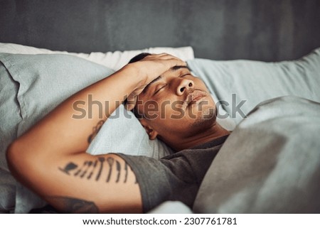 Tired, rest and sick man sleeping in the bedroom while in recovery or healing in his apartment. Burnout, illness and male person with a headache or fever taking a nap in bed at his modern home. Royalty-Free Stock Photo #2307761781