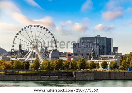 Observation Ferris wheel (La Grande Roue de Montreal) and cityscape of  Montreal in a sunny day, Quebec, Canada