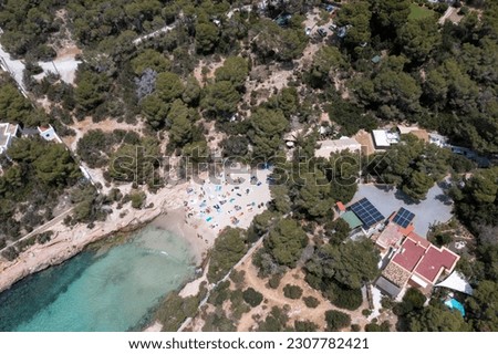 Aerial drone photo of a beach known as Cala Gracioneta in the town of Sant Antoni de Portmany on the island of Ibiza in the Balearic Islands Spain in the summer time.