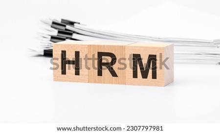 HRM wooden cubes word on white background. HRM - HUMAN RESOURCE MANAGEMENT concepts