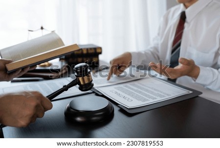 Lawyer or legal advisor finalizes the contract. Business legal agreements, constraints, consulting between lawyers and business clients, tax and legal firms. the concept of righteousness and justice Royalty-Free Stock Photo #2307819553